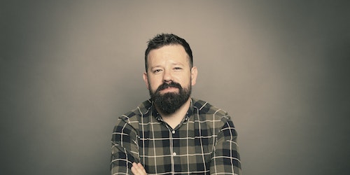 Dan Cullen-Shute in front of a grey background