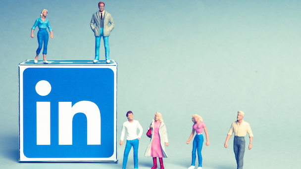 LinkedIn cube with logo and small plastic people figurines